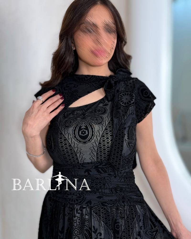 Black dress with an asymmetrical neckline and a slit