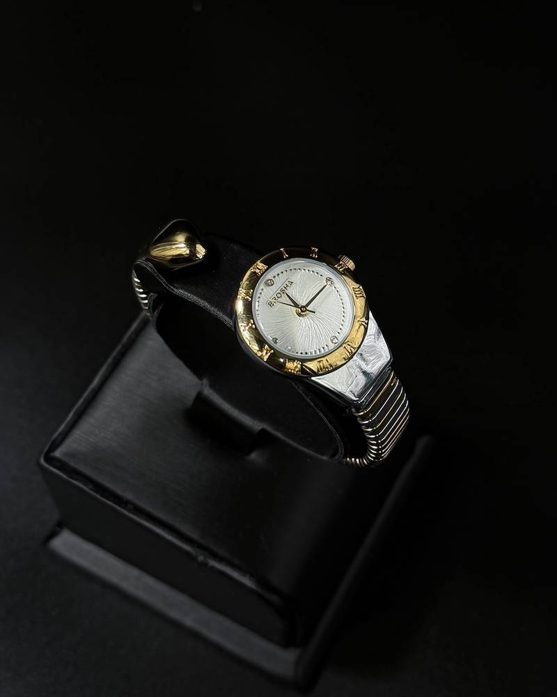 A women's watch with a delicate design and an open strap.