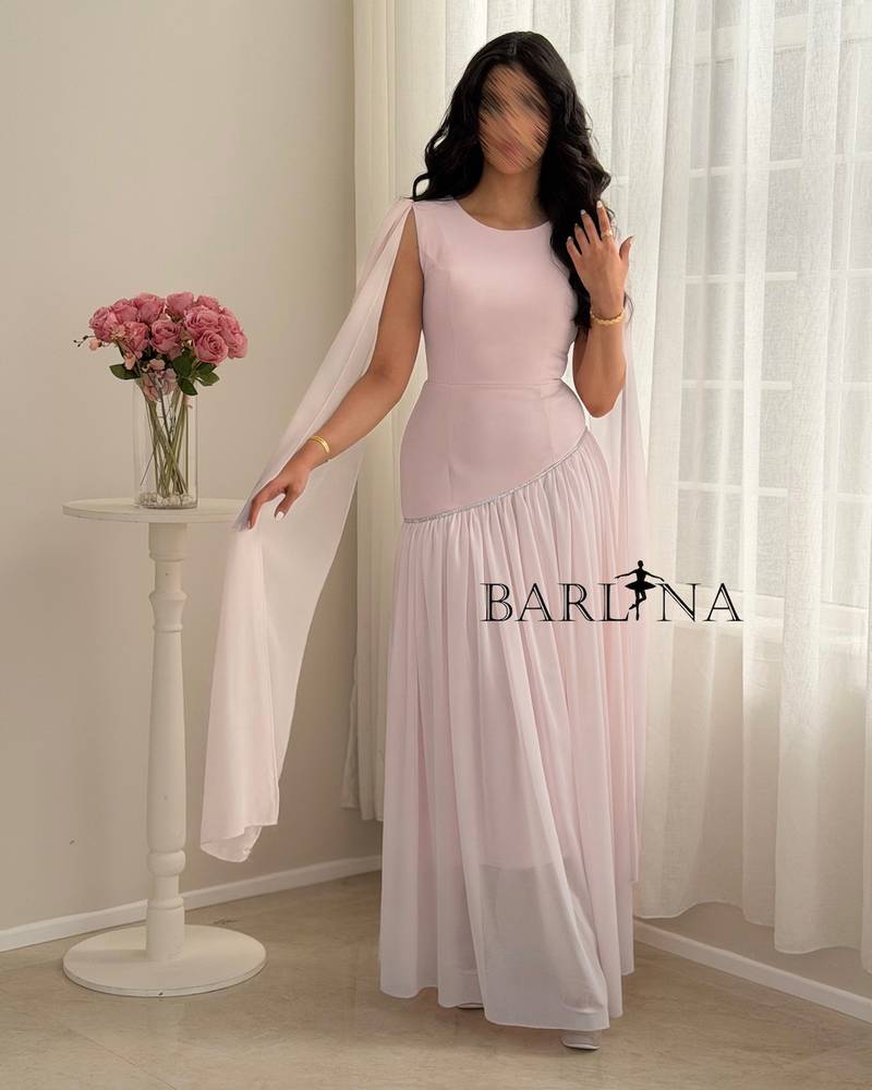 Pastel pink dress with a shawl over the shoulders