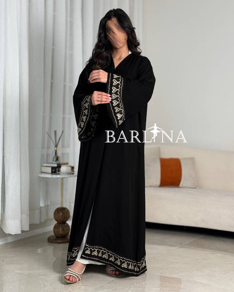 A soft black abaya with prominent beige embroidery