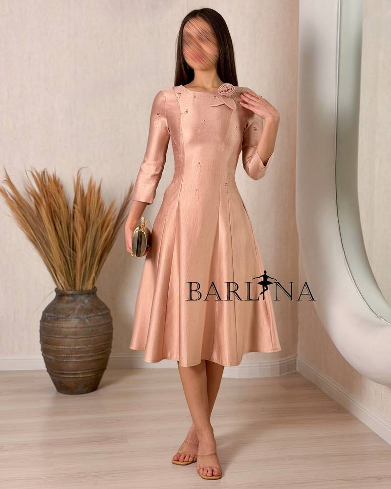 A soft midi dress adorned with a delicate rose