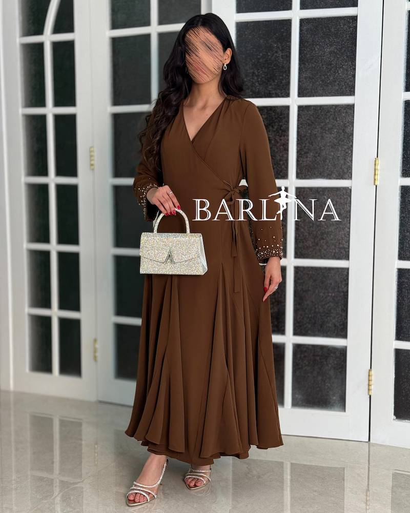 A soft brown dress with sleeves adorned with pearl embroidery.