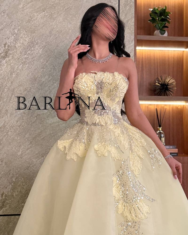 Light yellow evening dress embroidered with luxurious details