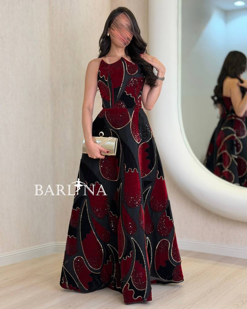 Black dress embroidered with red geometric patterns