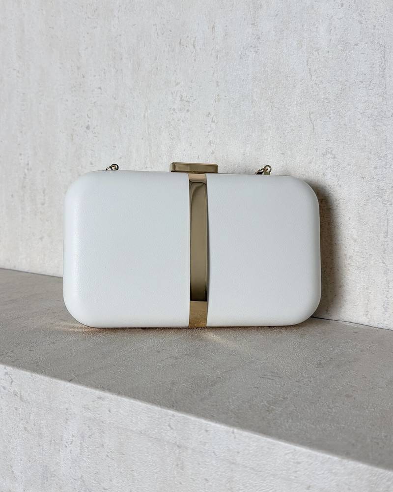 Evening bag decorated with a gold metal ribbon