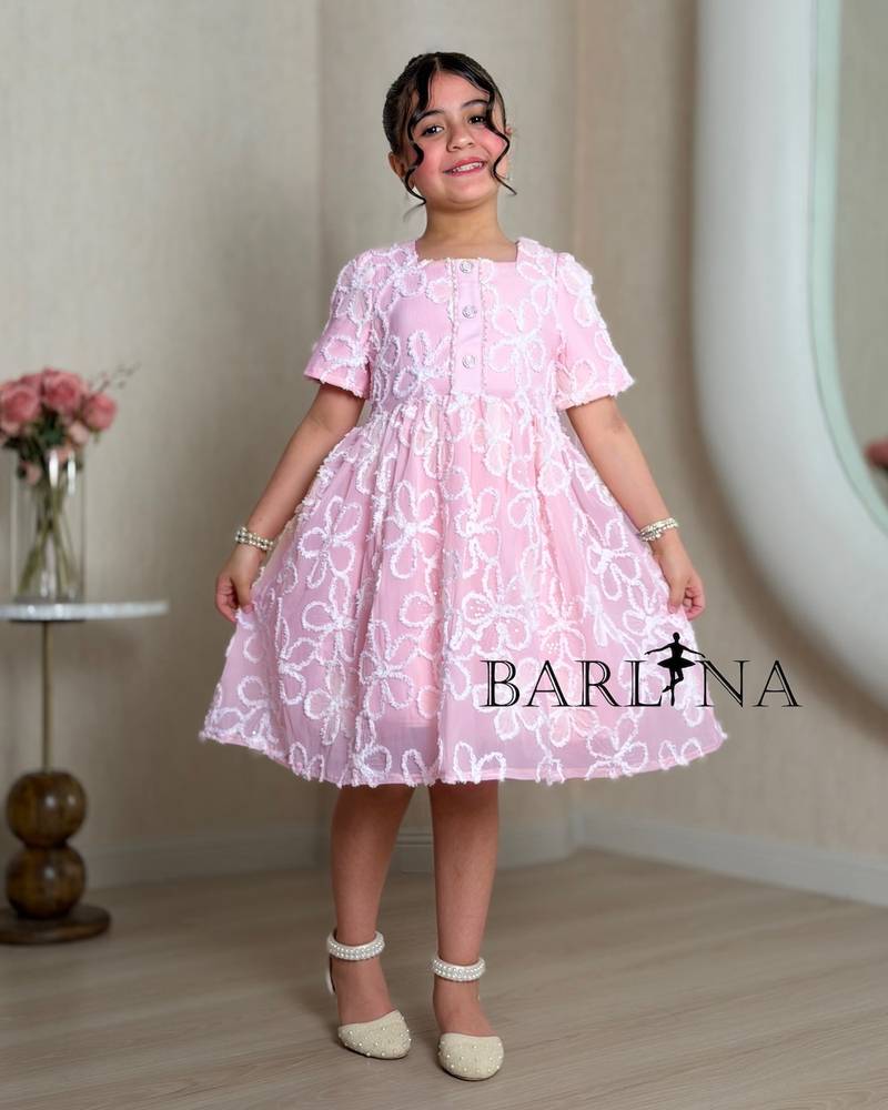 Pink girl's dress embroidered with white roses