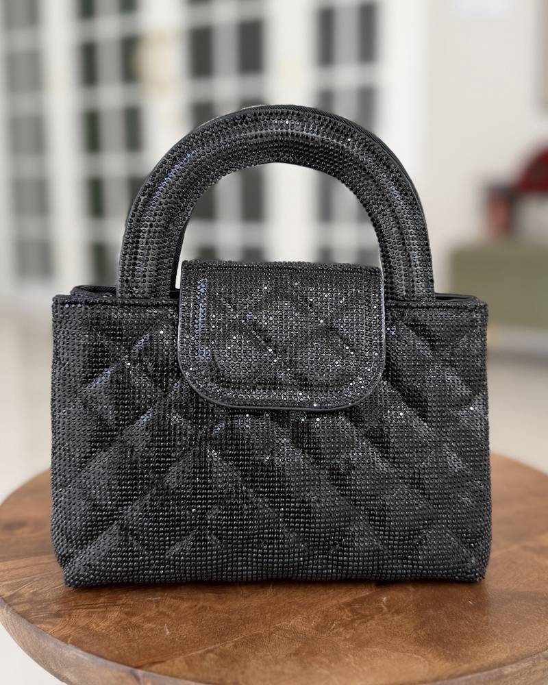 A square-shaped handbag with a stylish wide handle.