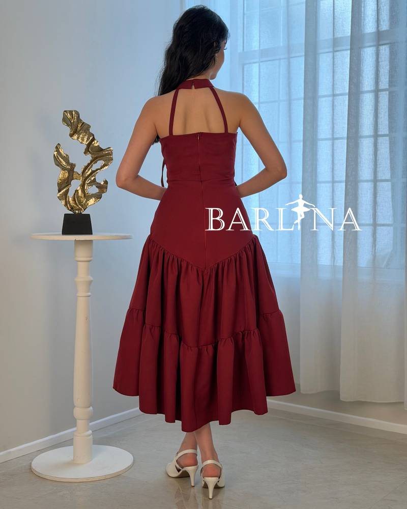 A soft burgundy dress adorned with elegant bows