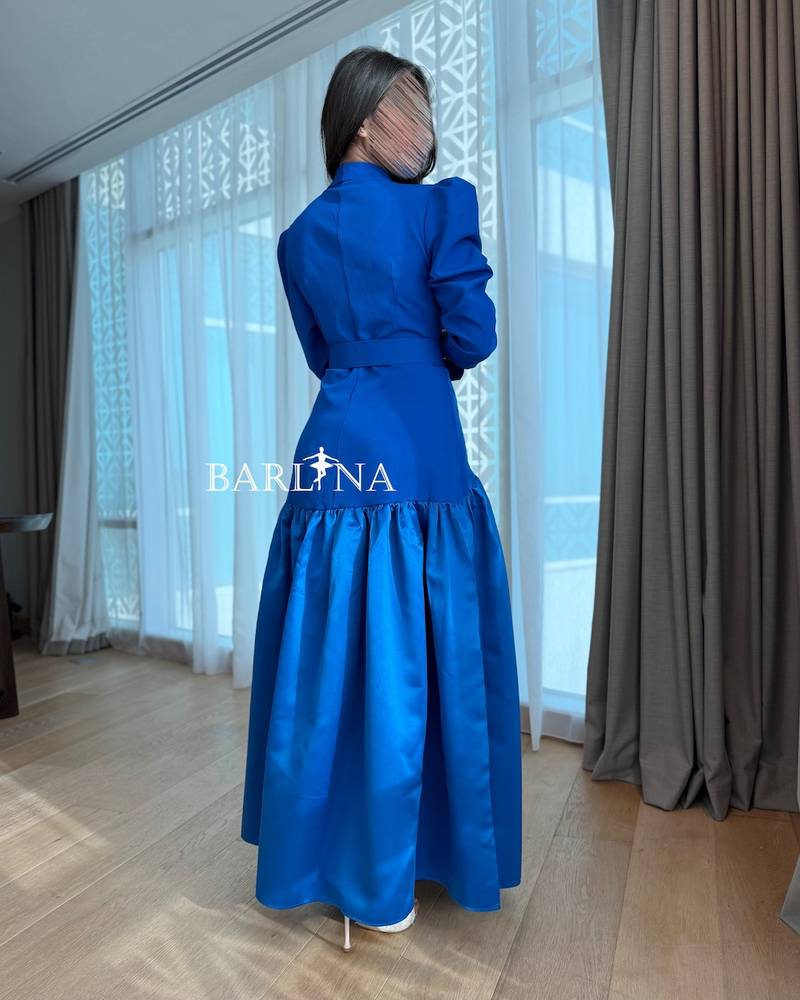Indigo blue dress with structured shoulders and a belt