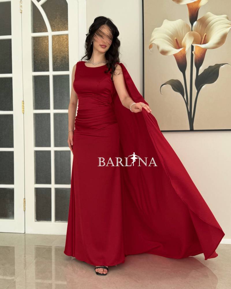 Red dress with a side cape and soft pleats