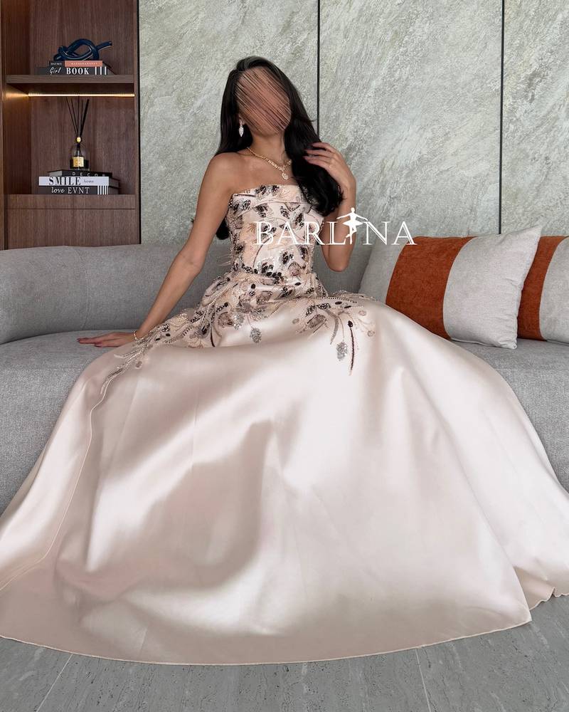 Cream evening dress embroidered with floral motifs