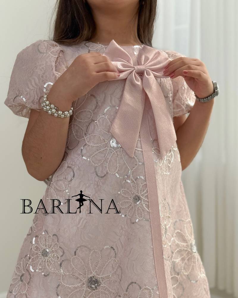 Pink girl's dress with floral embroidery and a bow