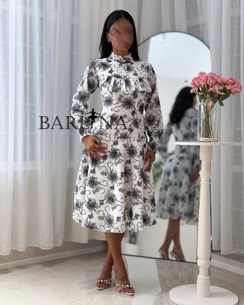 A soft white dress with black floral patterns