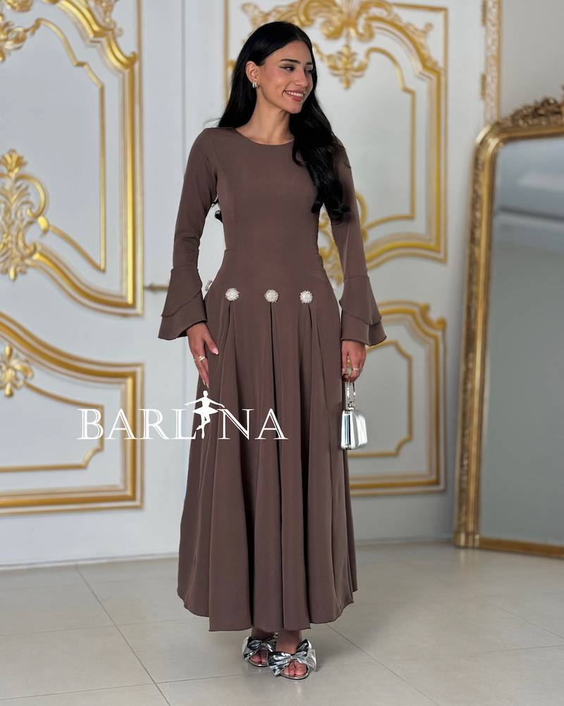 A brown dress with elegant decorative touches at the waist.