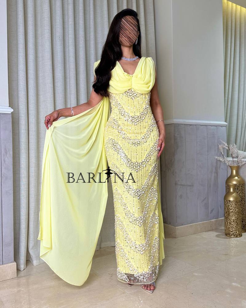Yellow dress with shiny embroidery and a long shawl