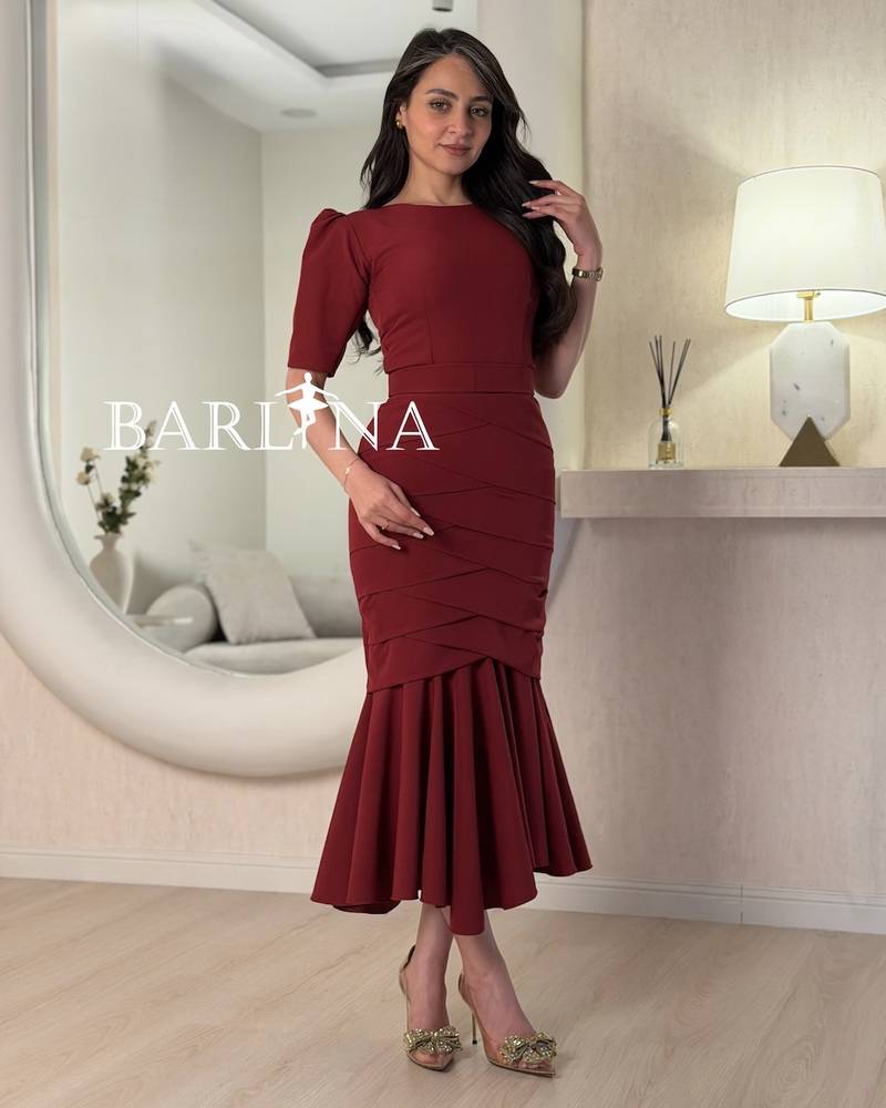 A burgundy mermaid dress with layered tiers