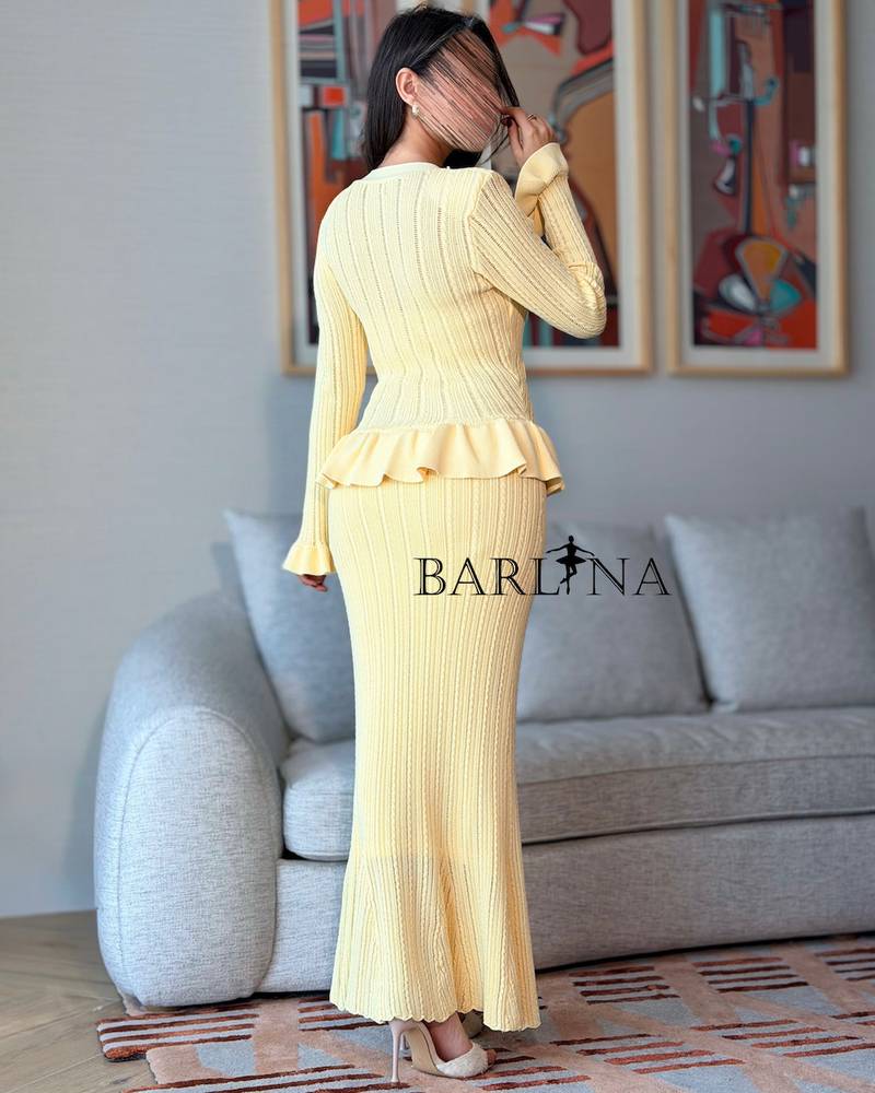 Yellow knitted dress with subtle pleats at the waist