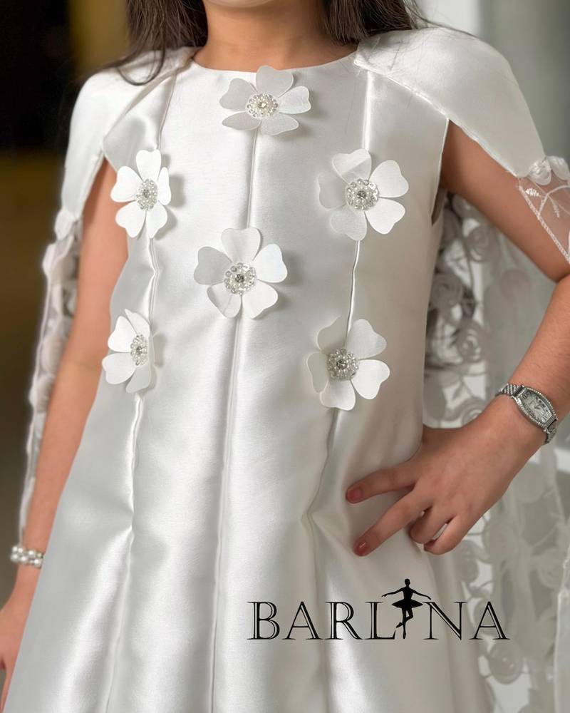 White dress with a lace cape and delicate embroidery