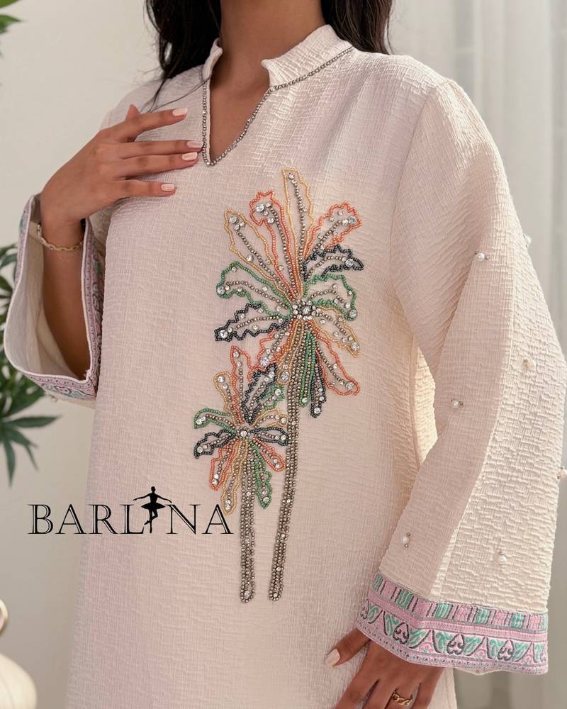 Ivory-colored jalabiya decorated with palm tree embroidery
