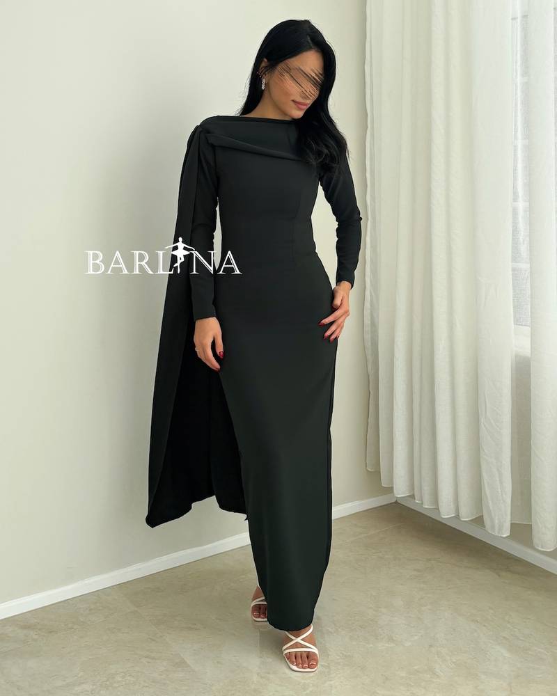 An olive-green dress with a draped cape over the shoulder