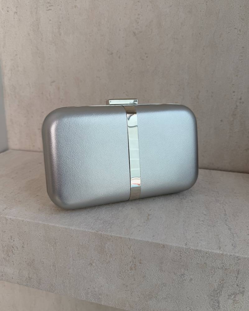 Evening bag decorated with a gold metal ribbon