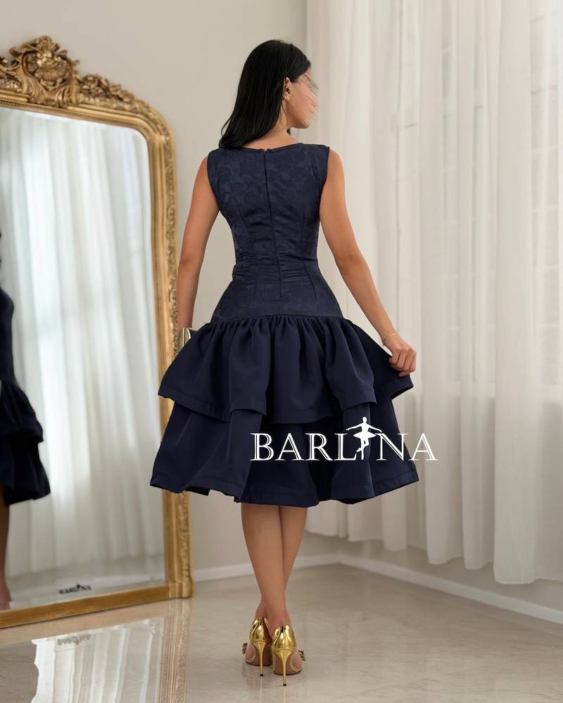 A soft dress with a low waist and layers of ruffles