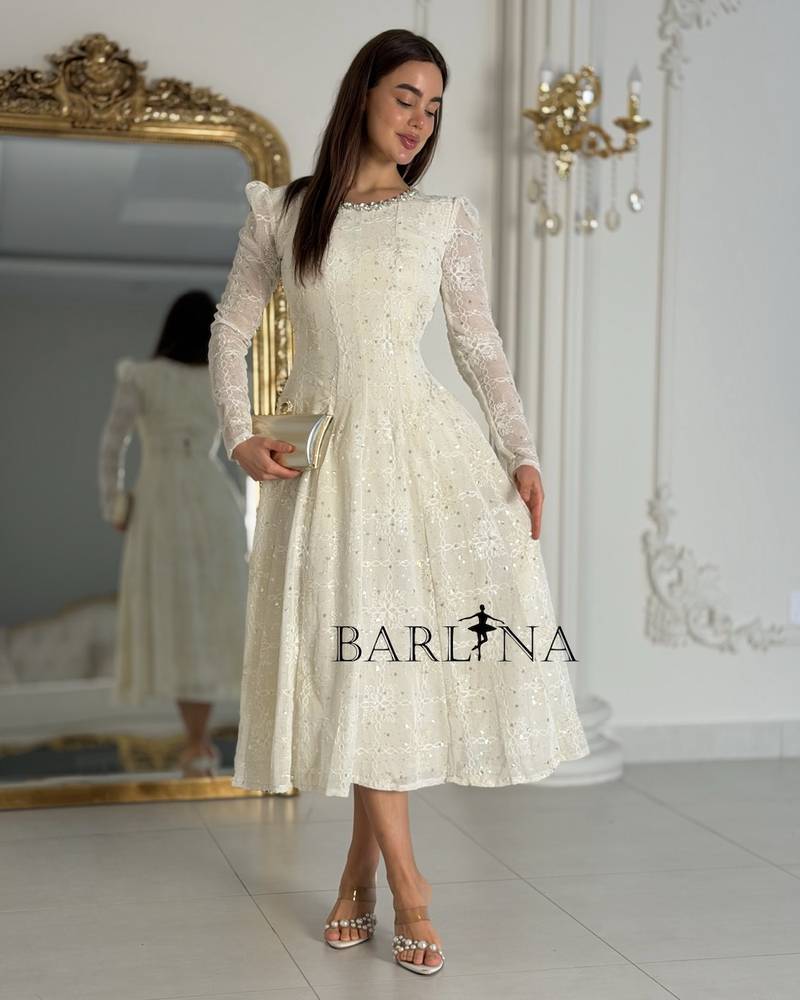 Elegant off-white dress with embroidery at the neckline