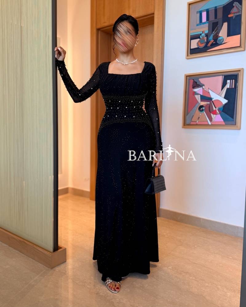Black dress with long sleeves adorned with pearls
