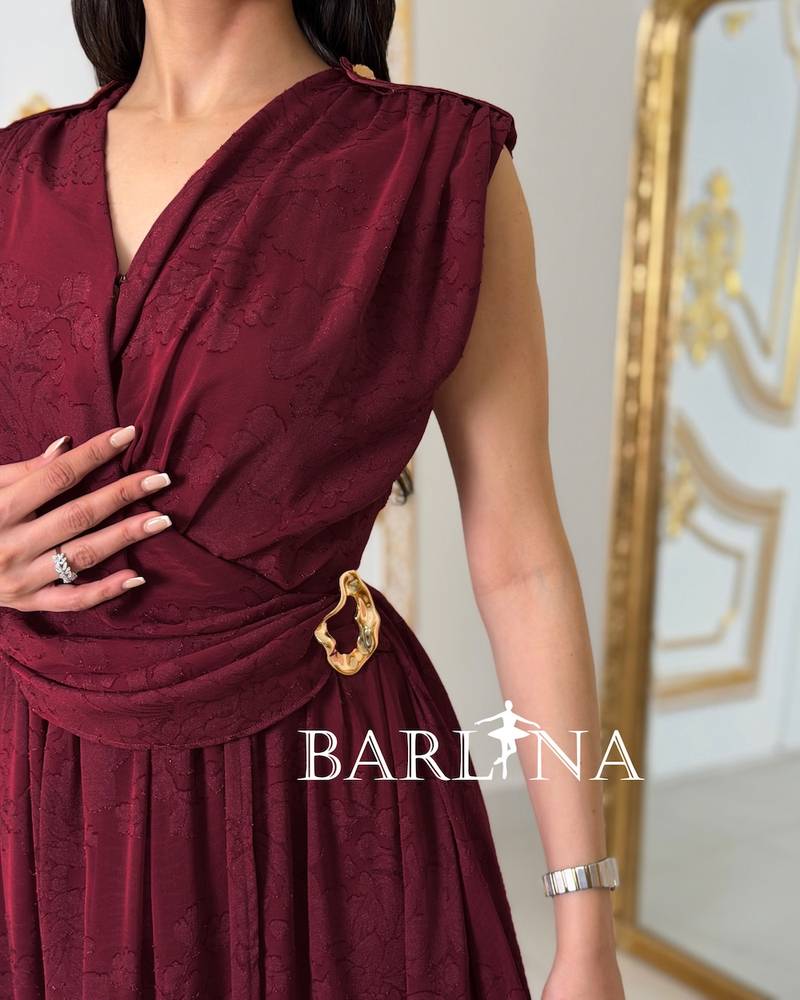 Red dress with a fitted waist and pleats