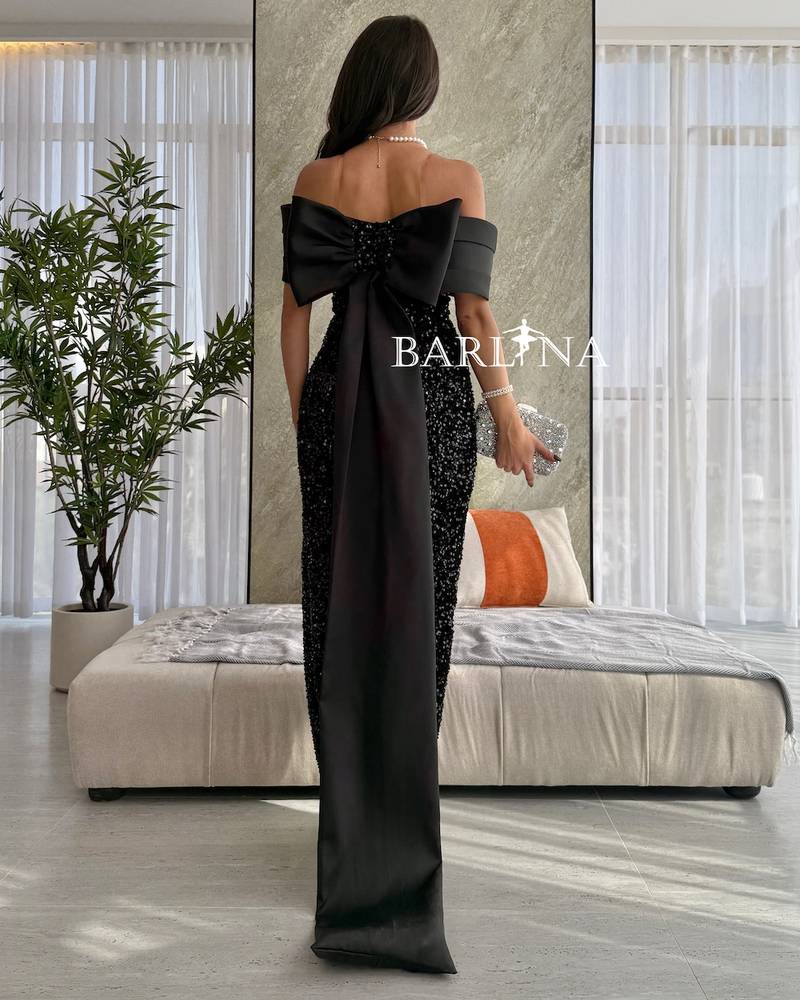 Black shiny dress with a long and distinctive design
