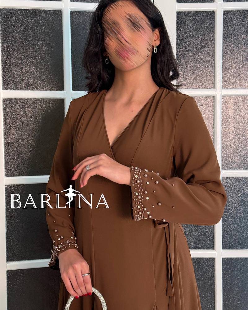 A soft brown dress with sleeves adorned with pearl embroidery.