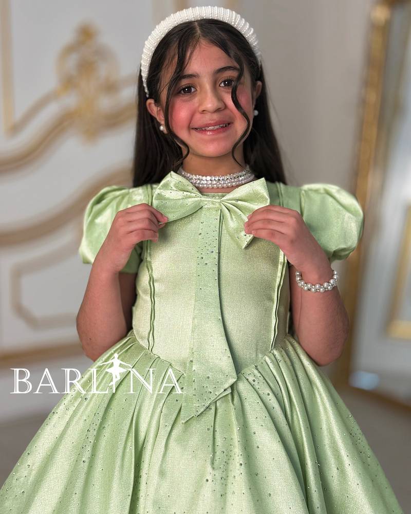 Elegant girl's dress with a bow on the chest