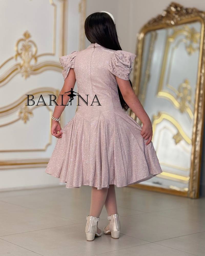A sparkly girl's dress decorated with pearls