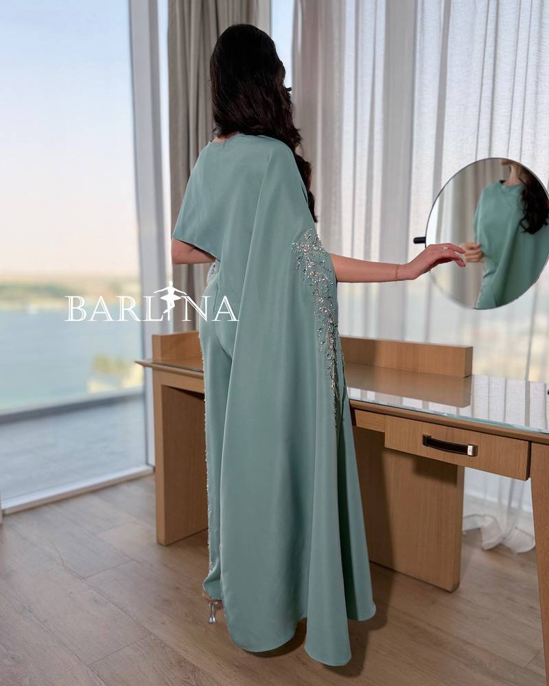 Tiffany jumpsuit with a side cape and shimmering embroidery