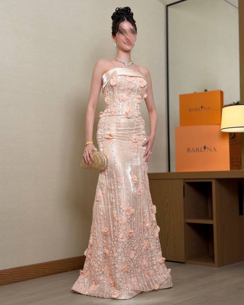 Elegant peach evening dress with an open neckline