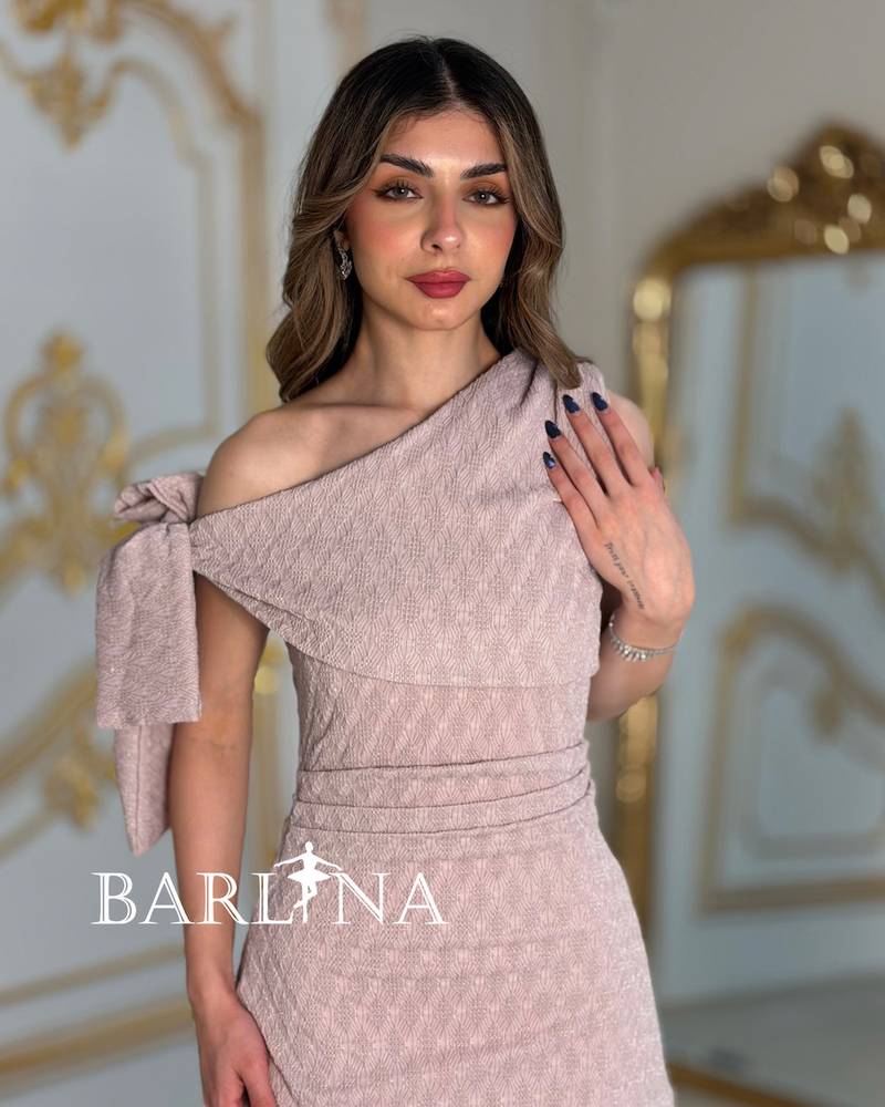 A soft dress with an elegant bow and layered details