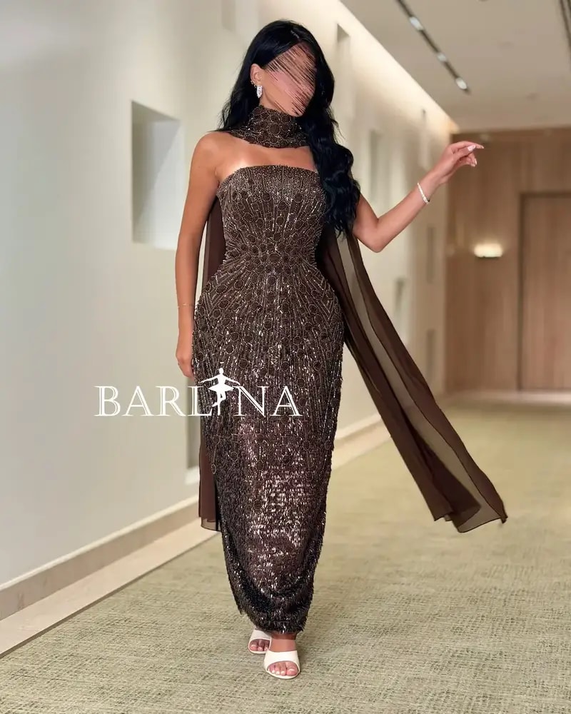 A shimmering brown dress with luxurious details and a shawl