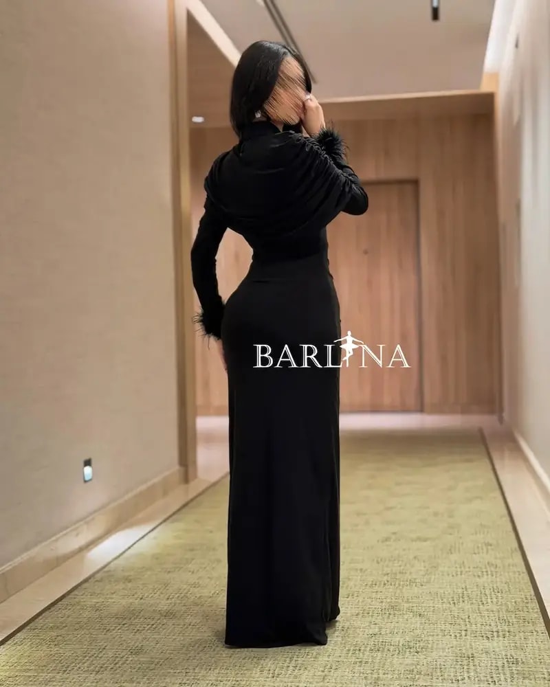 Black draped dress with feather-trimmed sleeves