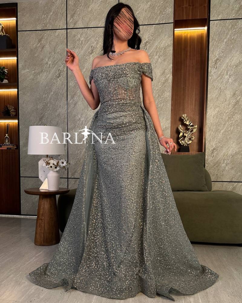 Luxurious evening dress with a beaded back train