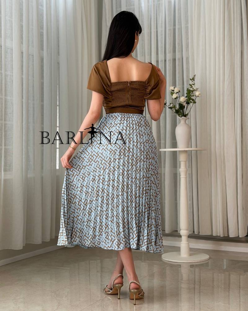 Women's set with a light blue pleated skirt and a brown blouse