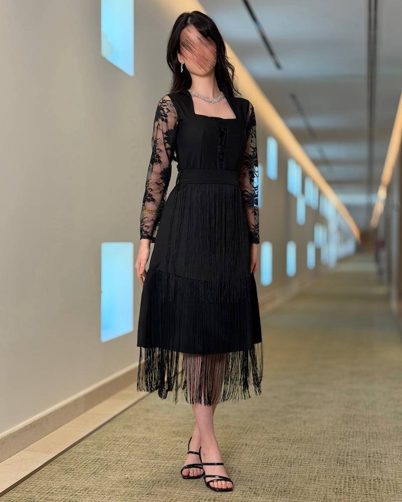 Black dress with lace sleeves and long fringe