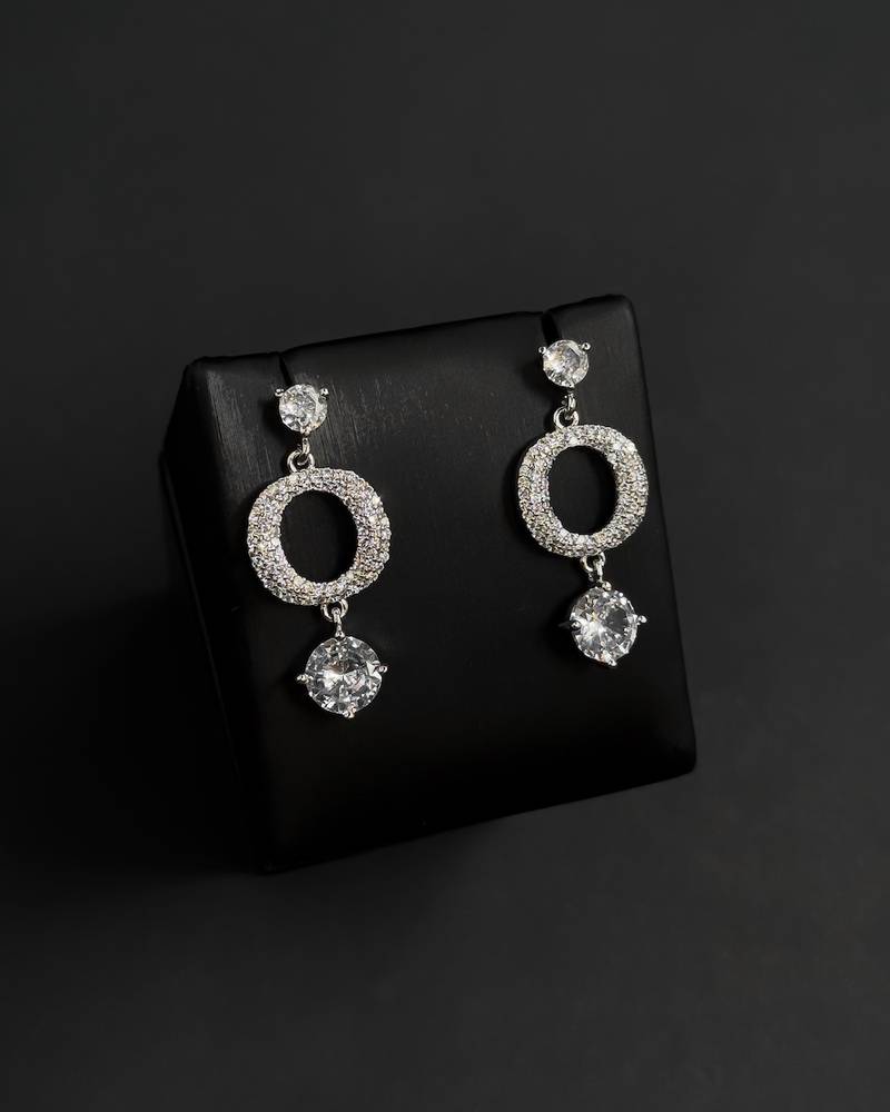 Elegant silver hoop earrings with a round, studded design