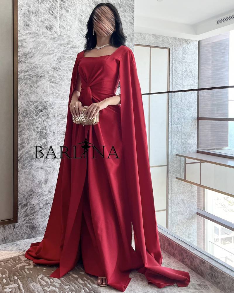 Long red dress with twisted design and cape sleeves