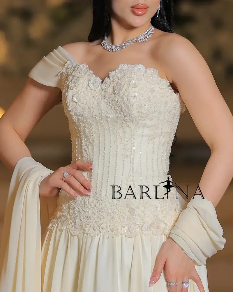 Royal ivory evening gown with draped sleeves
