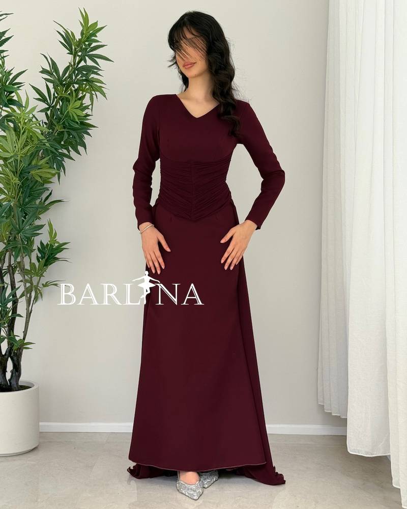 Dark burgundy dress with a gathered hem and a light train