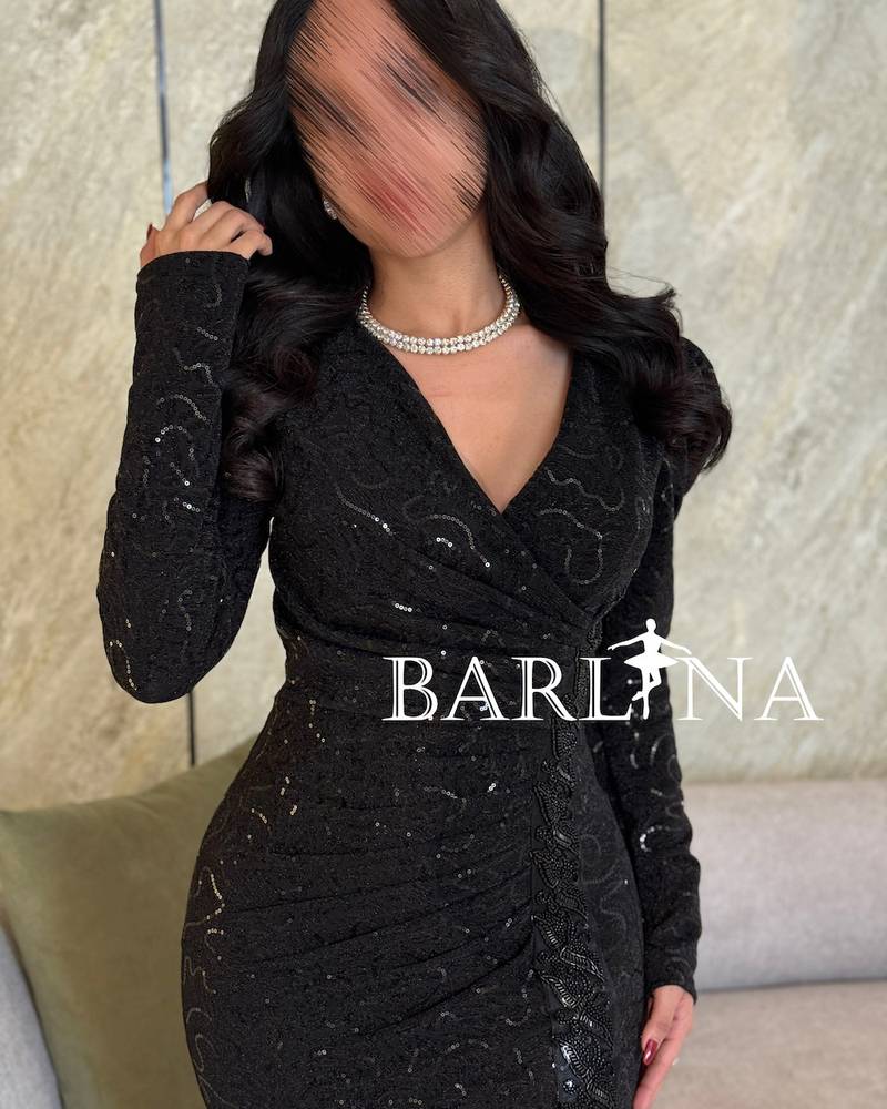Black embroidered dress with shiny touches and a side slit