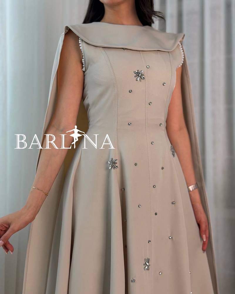Beige dress with a cape design embellished with crystals