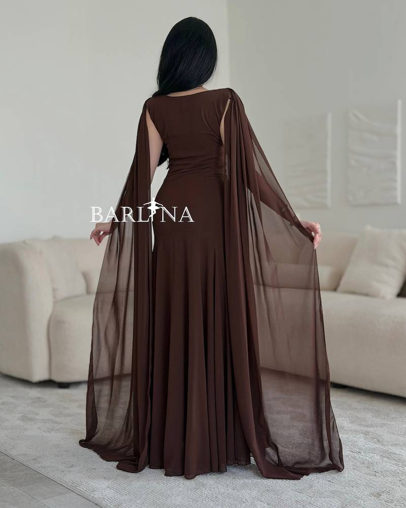 Brown dress with a long cape that drapes from the shoulders