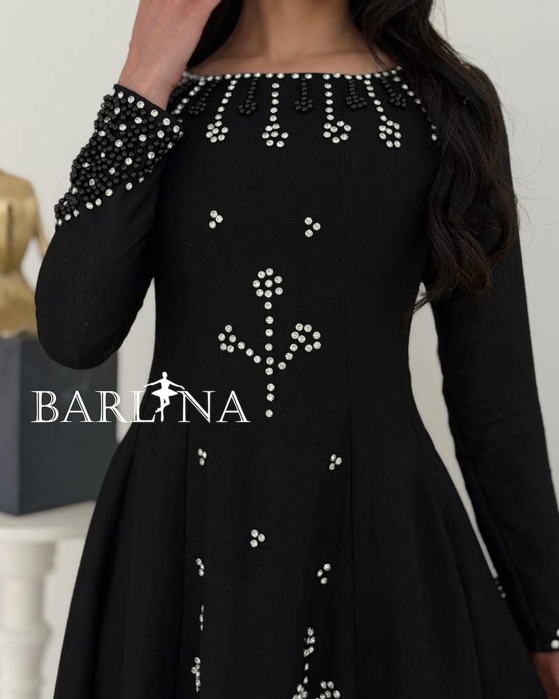 Black flared dress with pearl and crystal embellishments