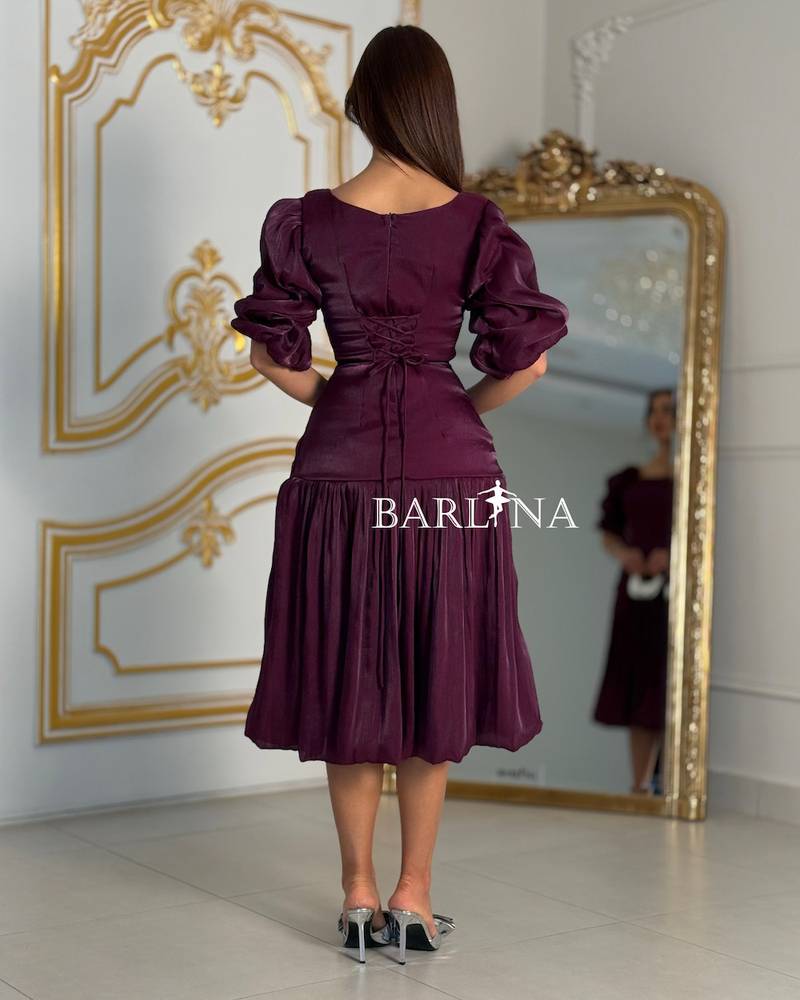A purple dress adorned with roses and a touch of pleats